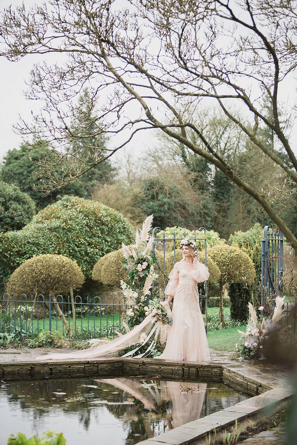 bride looking in water Barnsley House temple wedding photographer 