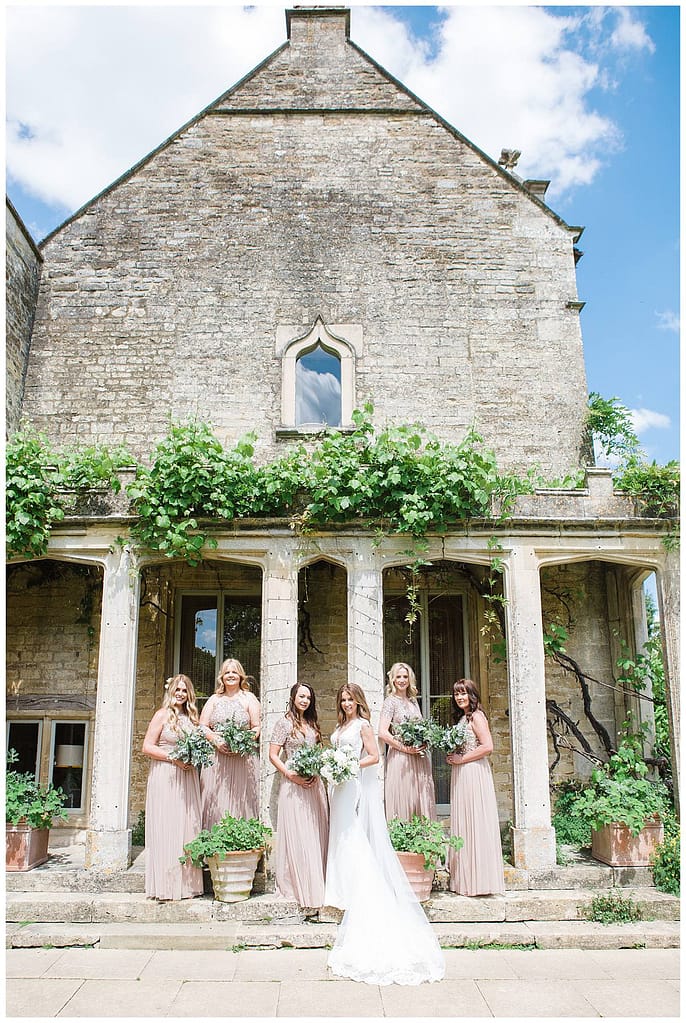 Barnsley House bridal party looking at Gloucestershire wedding photographer