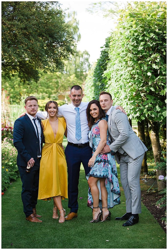guests posing for gloucestershire wedding photographer at Barnsley House