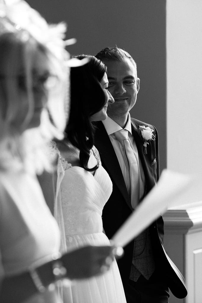 groom smiling at bride wedding photographer Elmore court