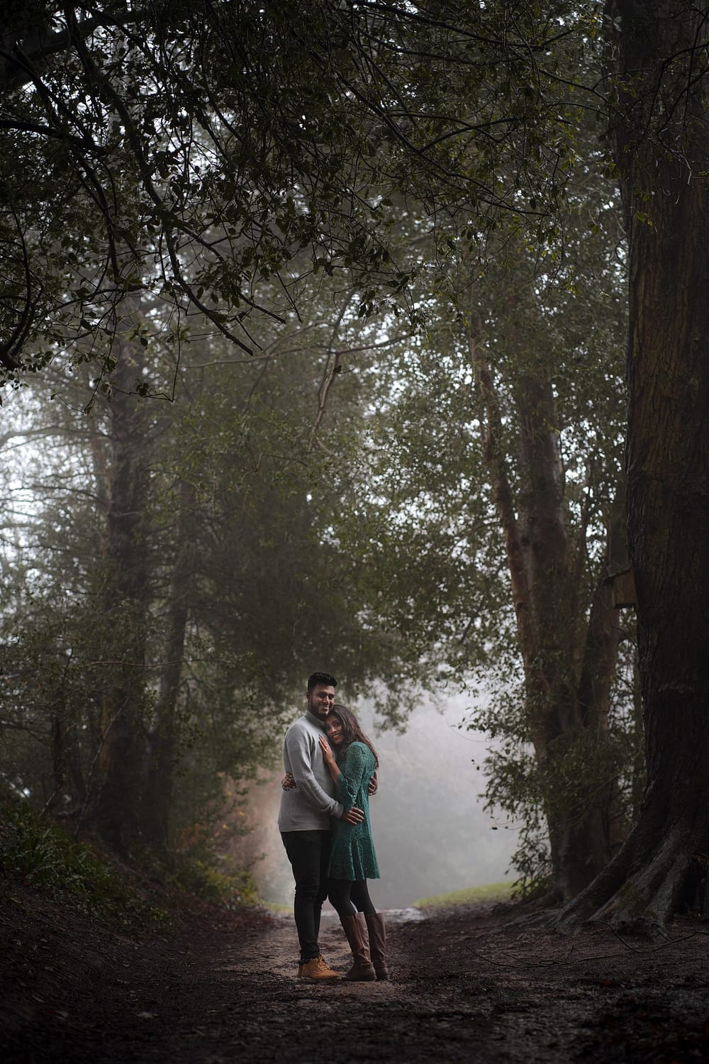 couple hugging amongst fog newark park