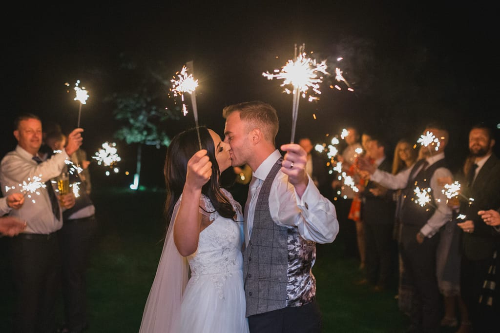 wedding couple holding sparklers at elmore court wedding