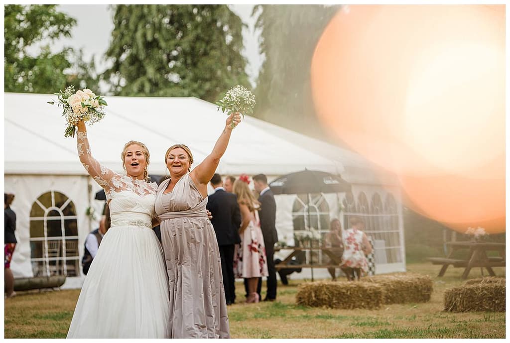 bride and bridesmaid excited Gloucestershire wedding photographers