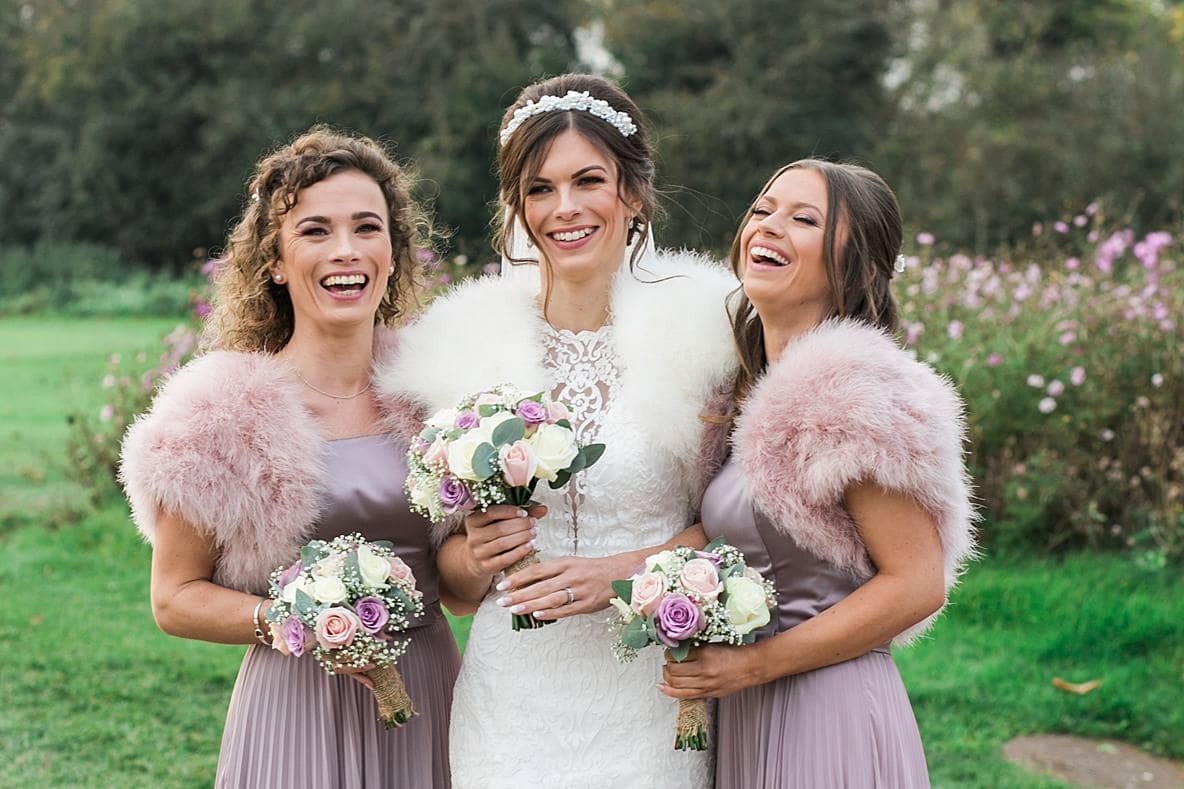 bride and bridesmaid laugh for wedding photographer thorn bury