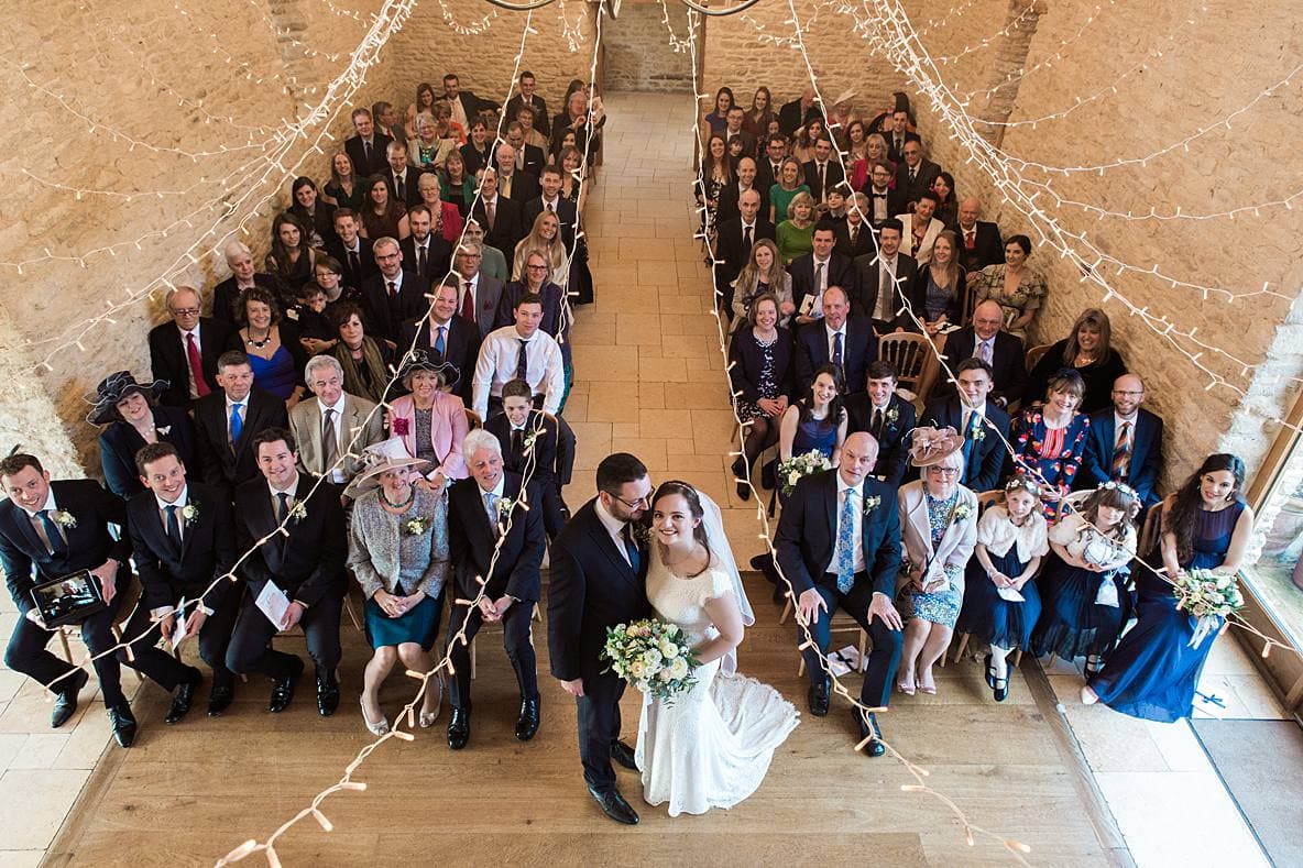 couple with guests formal picture Kingscote Barn January wedding