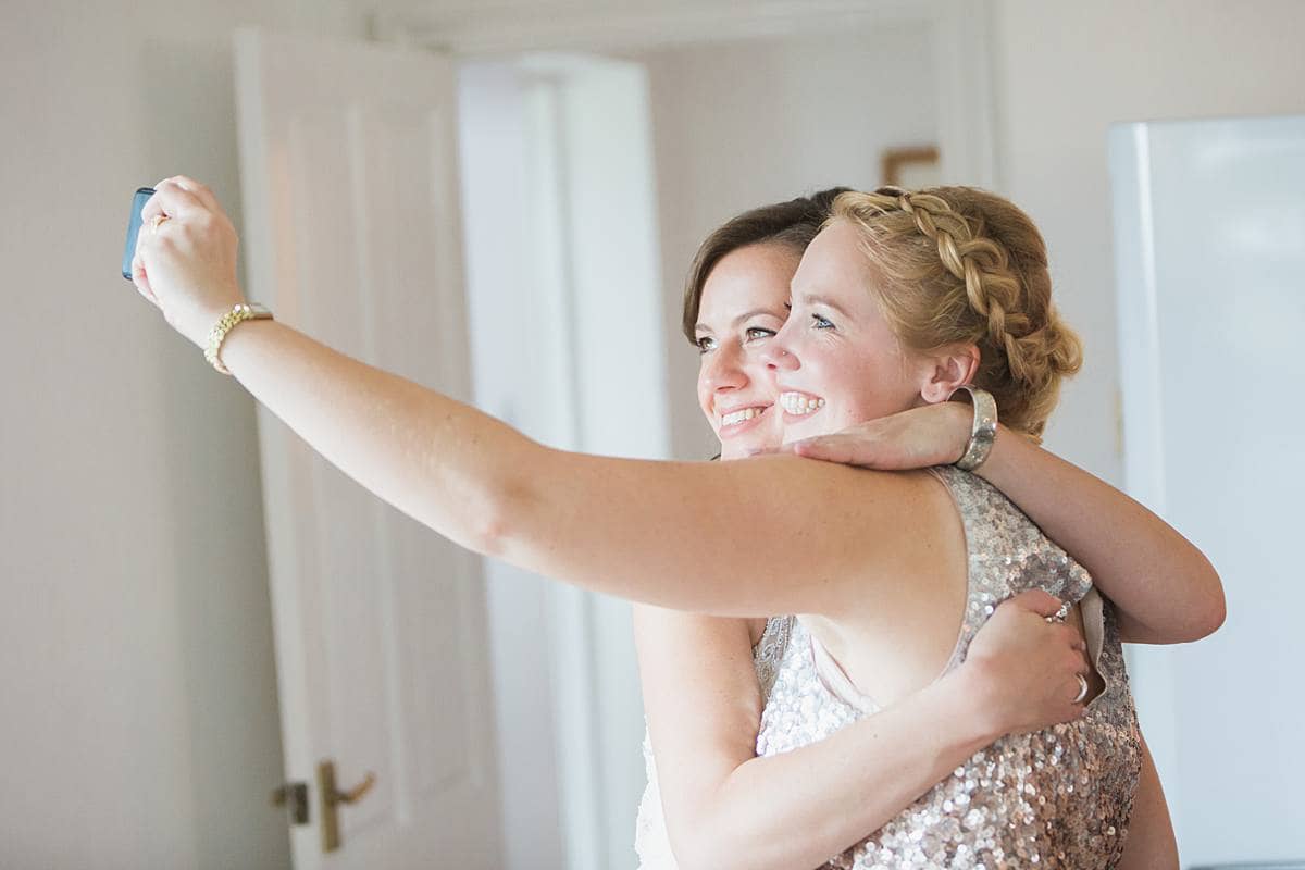 bride with bridesmaid making a selfie Glastonbury wedding photographer 