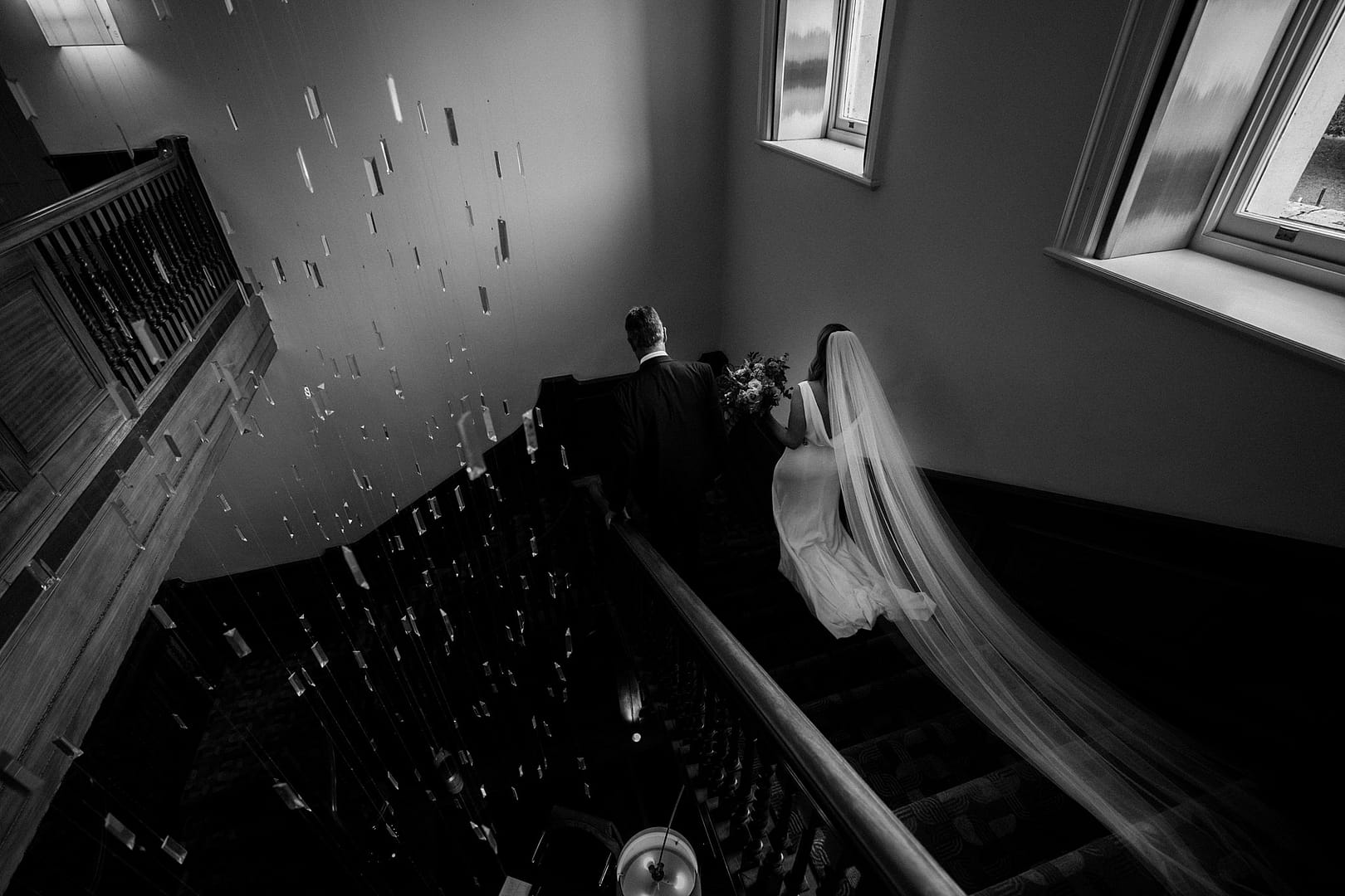 bride walking down cowley manor staircase