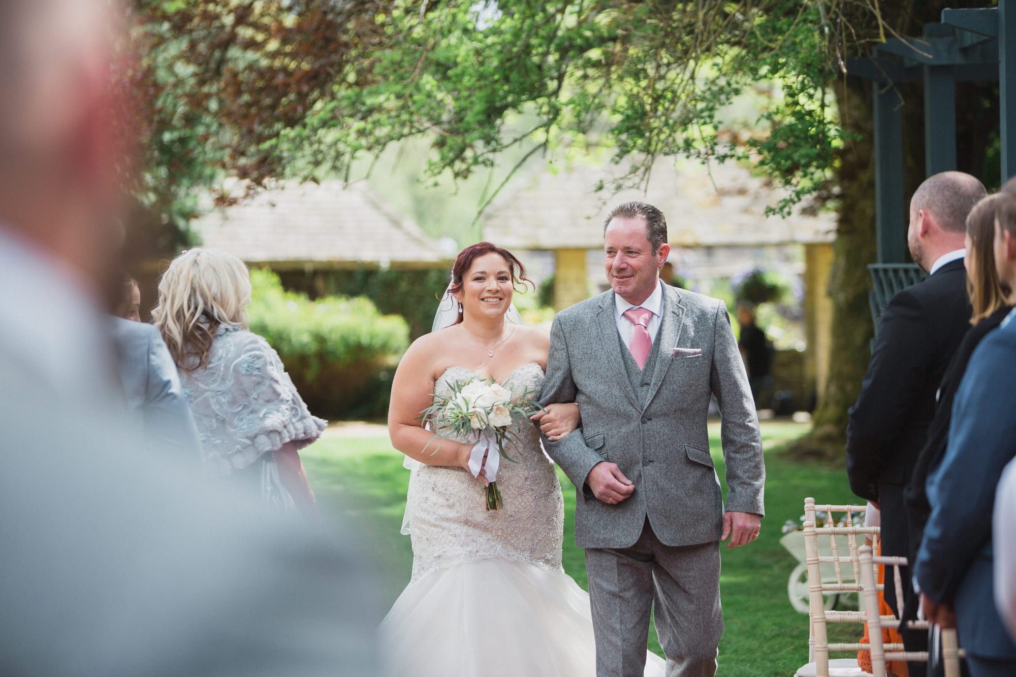 bride walking down aisle outdoor ceremony cotswold