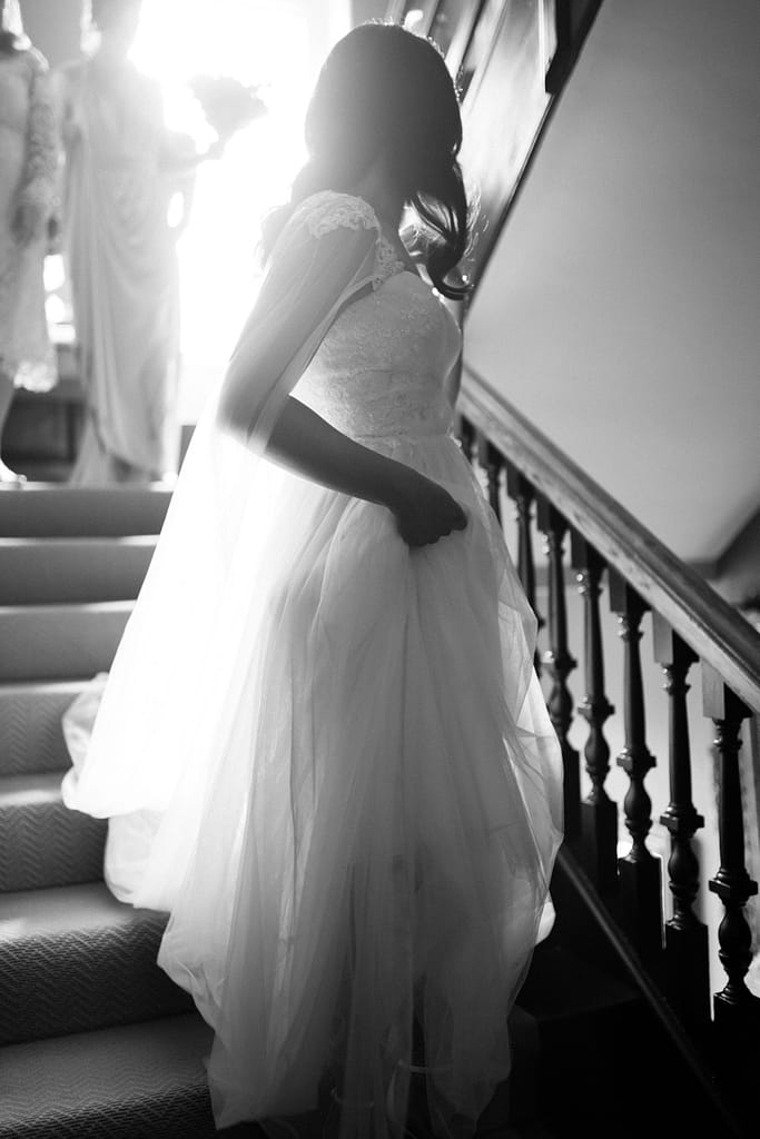 bride walking down staircase Elmore court wedding photography