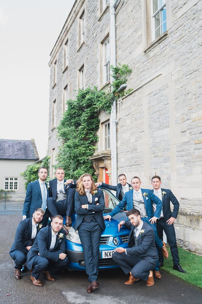 grooms party sitting on blue car Elmore court wedding photographer