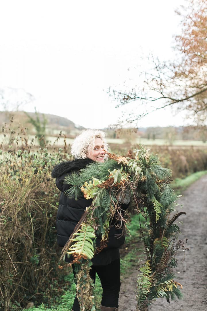 jules wild and co owner smiling with wreath