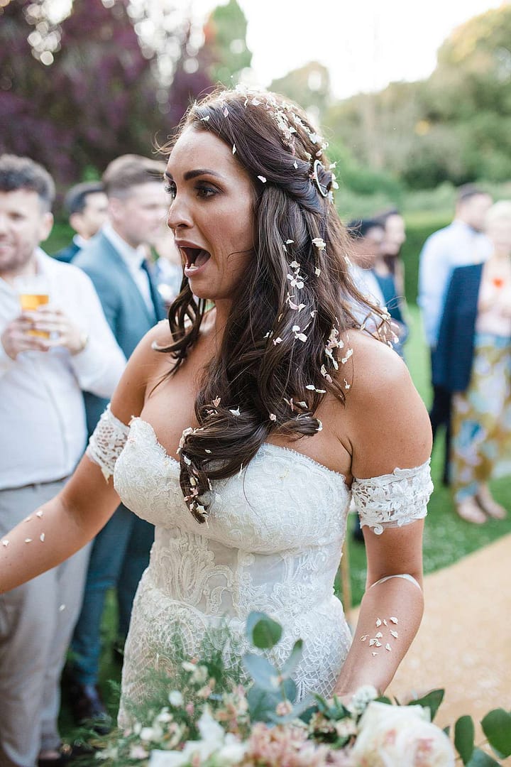 bride covered in confetti wedding photographer uk