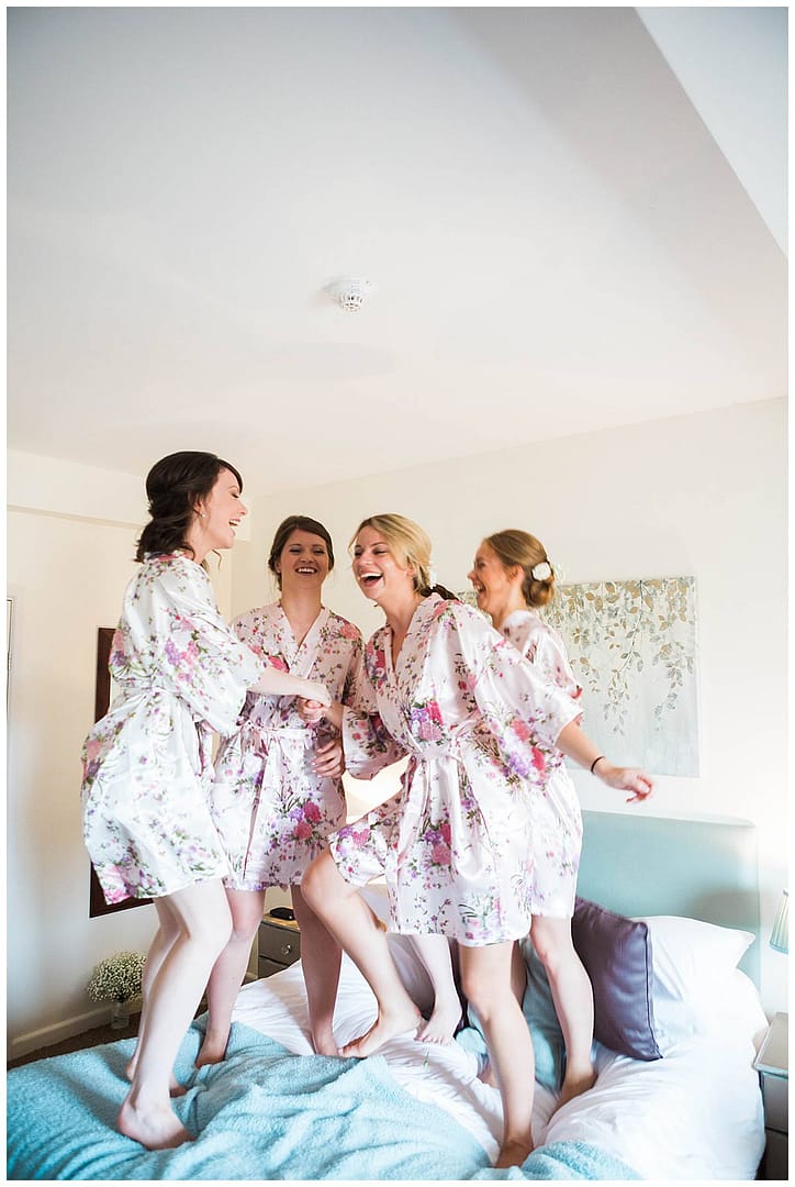 bridal party jumping on bed great tythe barn wedding photographers