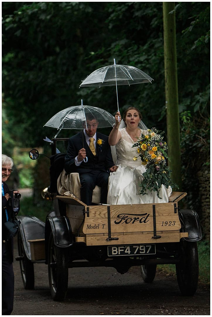 couple with umbrellas gloucestershire wedding photography